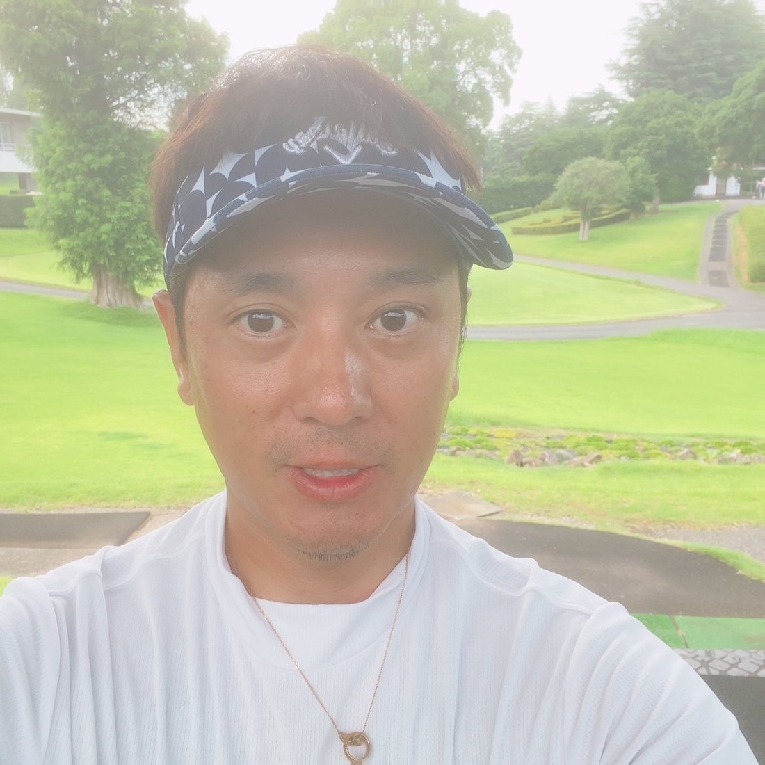 Muneharu Takemoto on a golf course fairway.